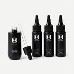 Set of black hair serum bottles with dropper and dermaroller on a light gray background contains descriptive text stating bottle size may vary, the 3 month supply will always come with 150mL of the OS-01 HAIR serum.