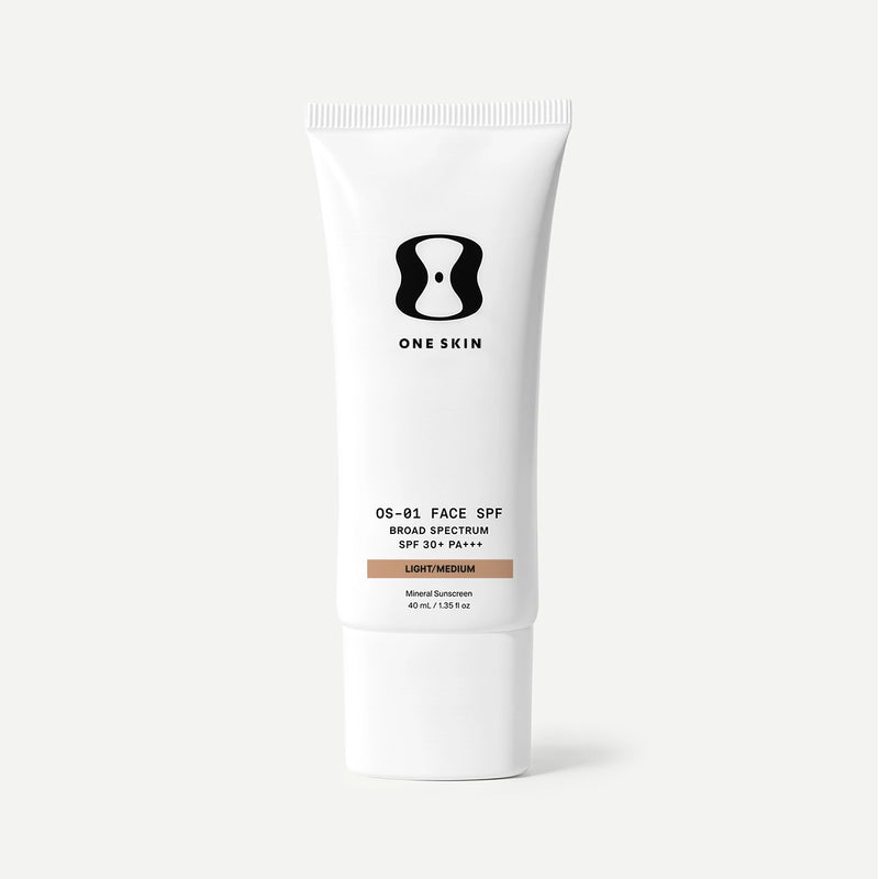 A white squeeze tube of One Skin OS-81 Face SPF Broad Spectrum SPF 30+ PA++ in Light/Medium, shown on a clean light gray background.