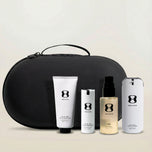 Set of skincare products with a black travel case on a light background